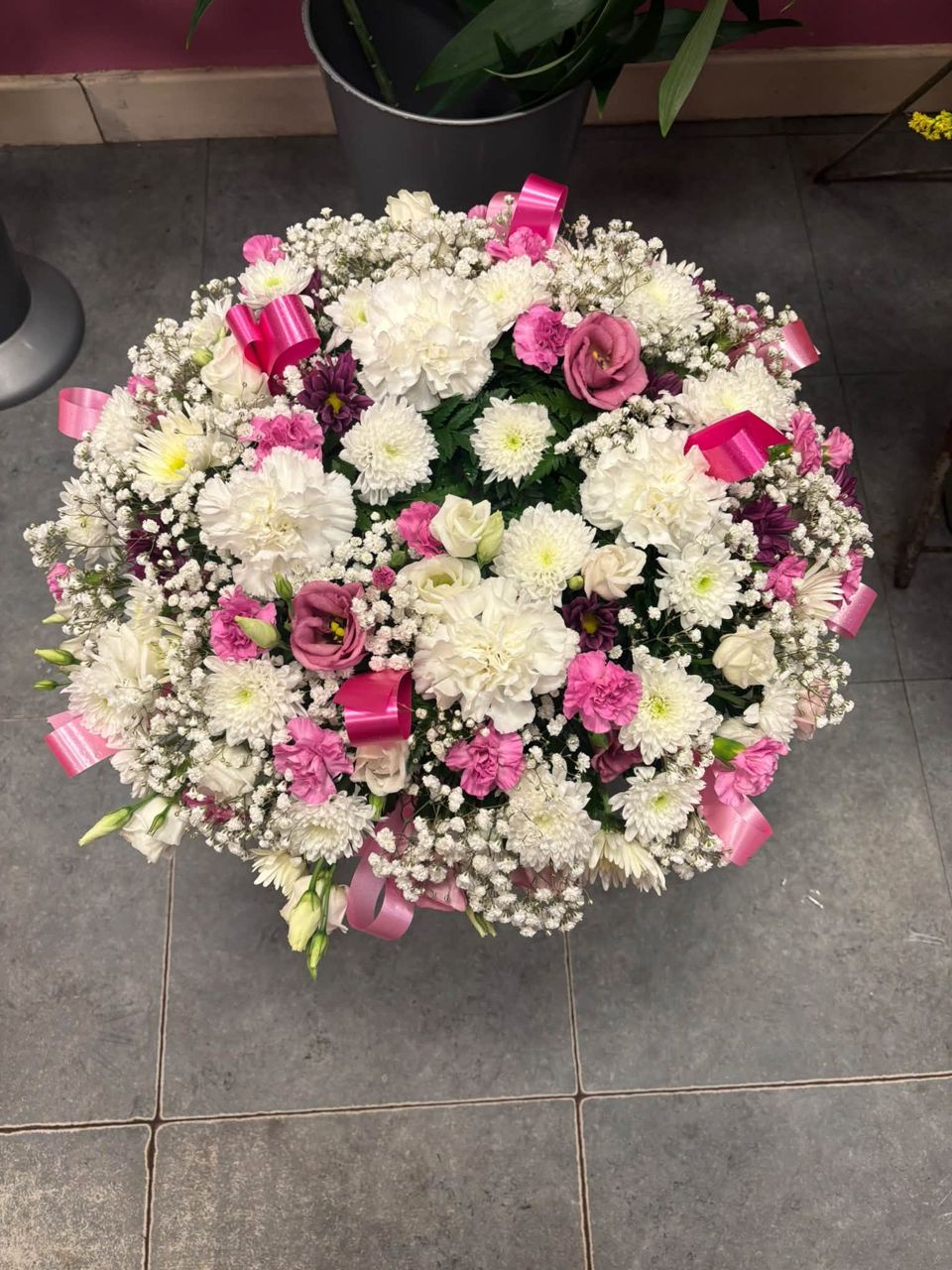 Round posy of pink and white roses with gypsophila